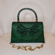 Womens dark green crystal encrusted luxury evening clutch bag with bow detail, gold embellishment, satin finish material and magnet front closing top  Can be used with or without long shoulder chain (included) size approx- H 14cm x W 22cm Free Royal Mail delivery is an estimated 3-5 days but this can occasionally be slightly longer which solely on the Royal Mail side. We do offer guaranteed next day delivery but please contact us prior to ordering as this would incur a small upgraded shipping charge. We also offer WORLDWIDE shipping - please contact us for more info 💕🌍 Glamorous Green Evening Bag, Green Rhinestone Party Evening Bag, Glamorous Green Clutch Bag, Elegant Green Bag For Night Out, Green Rhinestone Clutch Evening Bag, Glamorous Green Event Bag, Glamorous Green Rectangular Clutch, Elegant Green Evening Bag With Rhinestones, Elegant Green Evening Bag For Events