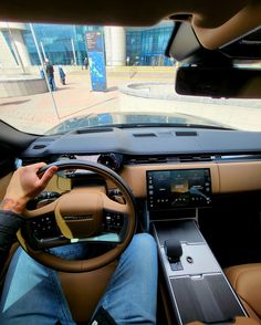 a person sitting in the driver's seat of a car