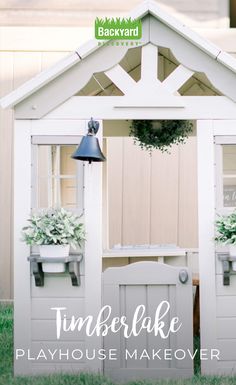 an outdoor play house made out of old doors and windows with plants in the window boxes