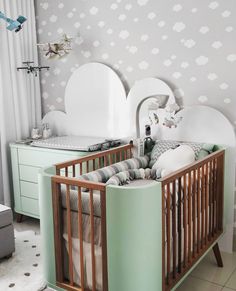 a baby's room with two cribs in it