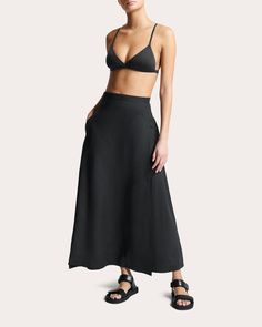 Set high on the waist, the Amalfi skirt ties at one side to create an overlapped wrap silhouette. The organic linen fabrication softens with wear and time. Button and wrap tie closure High-rise Side pockets 100% organic linen Dry clean Made in Portugal Size & Fit Garment measurements (size S): 36.22in long, 29.13in waist, 39.76in hips Model (wearing size S): 5ft 8in tall Fits true to size Size XS = US 2-4 / UK 6-8 Size S = US 4-6 / UK 8-10 Size M = US 6-8 / UK 10-12 Size L = US 8-10 / UK 12-14 Size XL = US 10-12 / UK 14-16 Sustainability Metrics: Organic Materials: at least 60% of materials used for production come from natural sources and do not contain harmful toxins or waste Read more about Olivela's sustainability pillars here. | Asceno Women's Amalfi Linen Wrap Skirt in Black Size XS Fitted Linen Maxi Skirt For The Beach, Chic Linen Lined Wrap Skirt, Chic Linen Wrap Skirt With Lining, Chic Linen Wrap Skirt With Lined Detail, Chic Long Linen Wrap Skirt, Chic Asymmetrical Linen Wrap Skirt, Linen Asymmetrical Skirt With Lining, Asymmetrical Linen Skirt With Lining, Asymmetrical Linen Lined Skirt