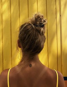 a woman with a flower tattoo on her back