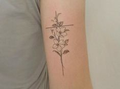 a small flower tattoo on the arm