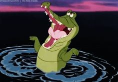 an alligator is in the water with its mouth open