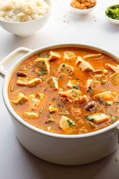 a white bowl filled with curry and tofu