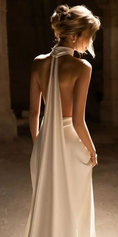 the back of a woman's dress with a halter neckline and draped over it