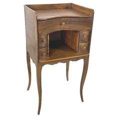 an antique wooden desk with drawers on one side and a drawer at the other end