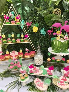 a table topped with lots of desserts and cupcakes