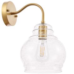 an antique brass wall light with clear glass shade and gold metal fittings on the arm