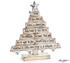 a christmas tree made out of wooden planks with writing on the top and bottom