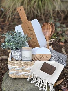 a basket filled with kitchen utensils sitting on top of a rock