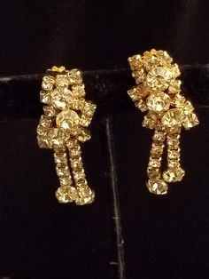 This is a Wonderful KRAMER of N.Y. vintage signed gold tone Rhinestone earrings. condition is very good vintage condition Vintage Yellow Gold Clip-on Earrings For Party, Vintage Gold Clip-on Earrings For Vintage Events, Gold Vintage Clip-on Earrings For Vintage Events, Gold Vintage Clip-on Earrings, Vintage Earrings With Sparkling Stones, Vintage Gold Clip-on Earrings With Rhinestones, Vintage Gold Crystal Earrings With Rhinestones, Gold Clip-on Costume Jewelry Earrings, Gold Clip-on Costume Earrings