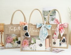 three bags with bows on them are sitting next to each other and the bag is decorated with flowers