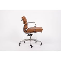 an office chair with brown leather upholstered on the back and chrome frame base