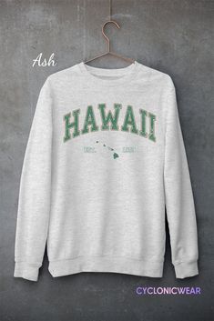 Vintage Style Hawaii Unisex Crewneck Sweatshirt SIZING: Sweatshirts are unisex regular fit. Pick your usual size for a normal fit or size up for a more relaxed feel. Please check size chart for exact dimensions. ITEM SPECIFICATIONS: :.DTG printed using water based eco-friendly inks for a very soft feel that won't peel off or fade after washing. NO VINYLS OR PLASTIC STICKERS USED. :.High Quality Unisex Heavy Blend™ Crewneck Sweatshirt .:50% pre-shrunk cotton, 50% polyester .:Loose fit .:Runs true Crew Neck Hoodie In Athletic Heather For College, Athletic Heather Crew Neck Hoodie For College, College Crew Sweatshirt With Screen Print, Athletic Heather Crew Neck Sweatshirt For Streetwear, Green Pre-shrunk Hoodie With Crew Neck, Green Pre-shrunk Crew Neck Hoodie, Athletic Heather Crew Sweatshirt With Letter Print, Heather Grey Crew Sweatshirt With Letter Print, Heather Grey Crew Neck Sweatshirt With Letter Print