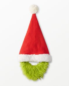 a red and green santa hat on top of a white wall