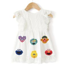 a white dress with sesame characters on it and the word one written in gold sequins