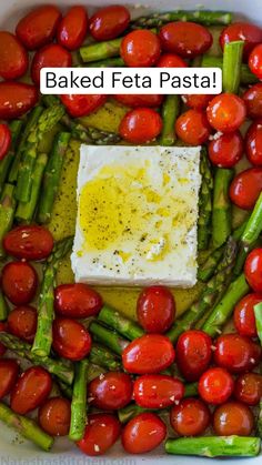 baked feta with asparagus and cherry tomatoes in a casserole dish