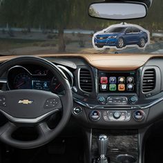 the interior of a car with an image of a blue chevy suv on it's dashboard