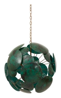 a green sculpture hanging from a gold chain