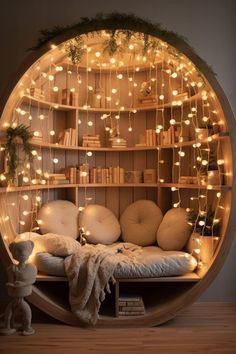 a circular bed with lots of lights in the middle and bookshelves behind it