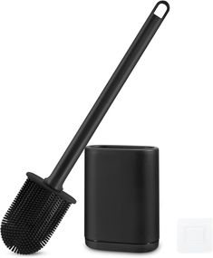 a black brush and container on a white background