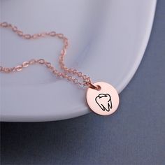 A 12mm (1/2 inch) disc is engraved with a tooth outline. Metals available include 14k rose gold filled, 14k gold filled and stainless steel pendant with sterling silver filled chain. Lengths available include 16, 18 or 20 inches. **ALL charms are optional! (shown with 1 added initial charm). Choose from initials, Swarovski crystal birthstones or other symbols. Tooth Outline, Tooth Necklace, Gifted Hands, Rose Gold Chain, Stainless Steel Pendant, Initial Charm, Rose Gold Necklace, Chain Lengths, Swarovski Crystal