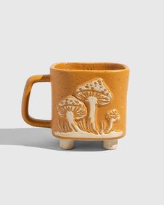 a yellow mug with an animal design on it