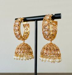 Gold Kundan Hoop Jhumka Earrings. Stylish Fancy Party Wear Jhumka Earrings .   Height: 2 inch Width: 1 inch These Jhumka Ear Rings can be worn with all kind of traditional Outfits.These beautiful Earrings are handcrafted in brass alloy with pearl stones of very fine quality. Ideal Gift for Wife, Girls, Women, Girlfriend.Ethnic Wear. Can be worn for engagement and wedding parties.  Handcrafted pair of earrings. Gives traditional look. Indulge in it or gift it and watch the compliments flow! It is advisable to store jewelry in a zip lock pouch (air tight pouch), keep away from water perfume and other chemicals and clean it with dry and soft cloth. FREE SHIPPING!! Hoop Jhumka Earrings, Hoop Jhumka, Kundan Jhumka, Pakistani Earrings, Pink Pearl Earrings, Water Perfume, Store Jewelry, Indian Earrings, Wedding Parties