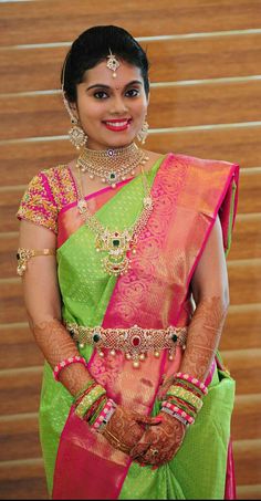 a woman in a green and pink sari