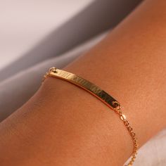 "This engraved bracelet features Roman numerals, adding a touch of personalization and elegance. Crafted with care, it's the perfect gift choice for her, reflecting both your thoughtfulness and the sentiment behind the date. Embrace the beauty of personalized jewelry and make her feel cherished with our Personalized Roman Numeral Bracelet, a meaningful and stylish accessory that she'll love to wear and treasure. #YOU MAY LIKE THIS silver bar cotton bracelet https://www.etsy.com/listing/149277659 Gold Charm Bracelet Gift, Classic Charm Bracelet As Gift, Personalized Yellow Gold Rectangular Name Bracelet, Personalized Rectangular Yellow Gold Name Bracelet, Classic Adjustable Gold Bracelet With Name Detail, Classic Adjustable Gold Bracelet With Name, Classic Gold Name Bracelet, 14k Gold Name Bracelet With Engraving Option, Classic Yellow Gold Charm Bracelet For Gift