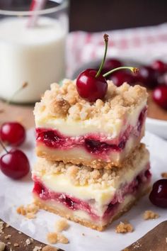 three pieces of dessert sitting on top of each other next to a glass of milk