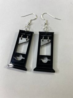 These fun guillotine earrings are the perfect way to show off your fun side. Each guillotine dangles from a hypoallergenic hook earring. Each guillotine is approximately 1 1/2 inches and are hand made Very light weight Stocking Filler Earrings Geek, Cute Weird Earrings, Weird Core Jewelry, Guillotine Aesthetic, Cursed Earrings, Funky Earrings Aesthetic, Weirdcore Earrings, Cool Earing, Unique Earrings Weird