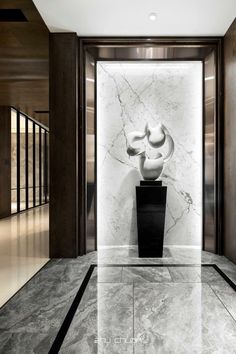 the entrance to an office building with marble flooring and walls in black and white