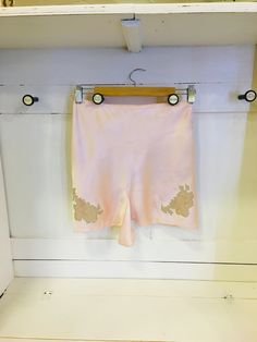 "C.1930's Silk and Lace Tap Pants With Genuine MOP Buttons  Gorgeous C.1930's Silk and Lace Tap Pants With Genuine MOP Buttons. In wonderful condition! Size small. Never worn. Peach Colour. No marks or stains. Genuine Mother Of Pearl Buttons down the side.  Waist: 26\"  Length: 15.5\" From hip to bottom of leg opening  Leg: 12\" Width These were purchased from the estate of a Society lady in the Toronto area - her estate had many unworn and/or unused items. Gorgeous gift for a loved one!" Vintage Fitted Loungewear Bottoms, Vintage Fitted Bottoms For Loungewear, Pink Stretch Vintage Bottoms, Fitted Vintage Bottoms For Loungewear, Vintage Stretch Short Length Bottoms, Vintage Stretch Bottoms For Daywear, Vintage Fitted Pink Pants, Vintage Pink Fitted Pants, Vintage Fitted Bottoms With Short Leg