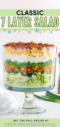 a layered salad in a glass dish with text overlay that reads classic 7 layer salad