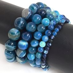 ✦Gemstone: Stripe Agate ✦Color: Blue ✦Shape: Smooth Round Beads ✦Size: 4mm, 6mm, 8mm, 10mm, 12mm ✦Average Strand Weight: < 4oz ✦QTY: 1 pc / package ♕Beautiful & High Quality Bracelet♕  Our bracelet length 7.5", fit with a 6.75" wrist, it is our standard size. We offer to resize bracelet 5"-8" to fit your wrist! If you like the different bracelet lengths, please let us know your wrist size. We are happy to take care of it for you. You can see our Personalization Option. Thank you! MEASURE YOUR WRIST:    - Measure around at the wrist bone in tape or even a strip of paper.   - Choose a place where you would normally wear a bracelet.  Make it as loose or snug.   - To use the strip of paper, mark where the end of the bracelet needs to be and then measure the paper with a ruler.   - Increase the Agate Rocks, St Patrick's Day Gifts, 2 Birthday, Saint Patrick's Day, Agate Bracelet, Saint Patrick, Blue Agate, Mens Jewelry Bracelet, Perfect Christmas Gifts