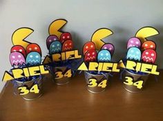 an arrangement of decorated easter eggs in buckets on a table with the number 34