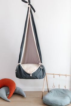 a hanging chair and bed in the shape of an elephant, with two pillows on each side