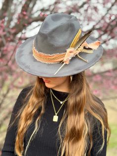 Gray wide brim fedora decorated with pink and gold hat bands, and two feather accents. Gold Wide Brim Bohemian Fedora, Gold Wide Brim Fedora For Festivals, Gold Fedora With Short Brim For Festivals, Gold Fedora Hat For Festival, Adjustable Fedora With Feather Trim For Kentucky Derby, Fedora Hat Bands With Feather Trim For Country Events, Adjustable Fedora With Feather Trim And Curved Brim, Adjustable Fedora Hat Band With Feather Trim, Adjustable Wide Brim Hat With Feather Trim