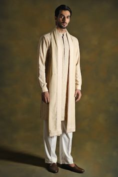 Oyster faun kurta with floral embroidered front and artistic geometric patterns on the arms. Comes with white pant and embroidered stole. - Aza Fashions Festive Traditional Wear Straight Kurta With Embroidered Sleeves, Traditional Drape Kurta With Embroidered Sleeves, Traditional Kurta With Embroidered Sleeves For Transitional Season, Traditional Kurta With Embroidered Sleeves For Eid, Fitted Kurta With Embroidered Sleeves And Traditional Drape, Diwali Embroidered Sleeves Straight Kurta, Designer Embroidered Kurta With Traditional Drape, Traditional Kurta With Embroidered Sleeves For Festive, Traditional Kurta With Embroidered Sleeves