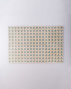 a piece of paper with dots on it in front of a white wall and floor