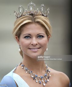 a woman wearing a tiara and smiling at the camera