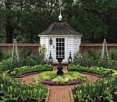 a garden with a gazebo surrounded by lots of plants