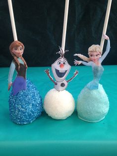 three frozen princess cake pops are on display