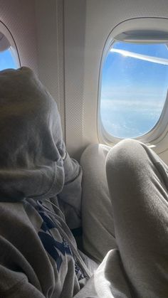 the view from inside an airplane looking out at the clouds and blue sky through the window