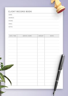 a printable client record book next to a pen