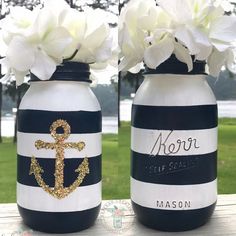 two mason jars decorated with flowers and an anchor painted on the front one is blue and white