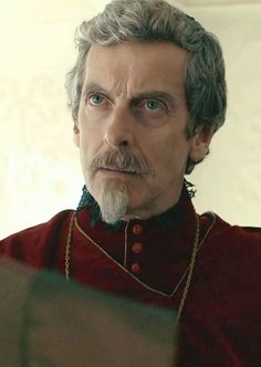 a man with grey hair wearing a red outfit