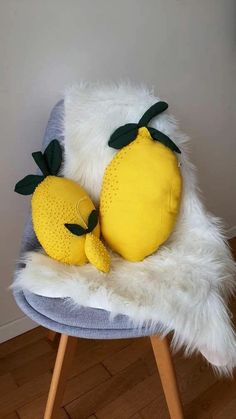 a stuffed lemon sitting on top of a chair